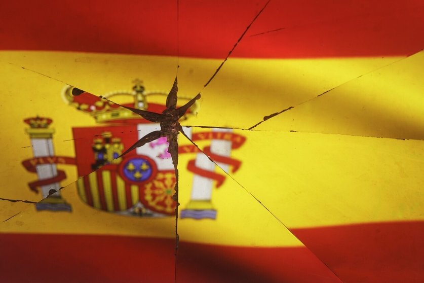Spain flag is reflected in broken mirror